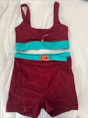 Fabletics Maroon Athletic Shorts with Teal Waistband and Orange Accent